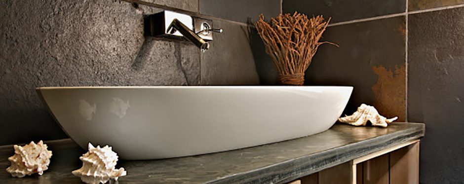 A white slate sink in a bathroom.