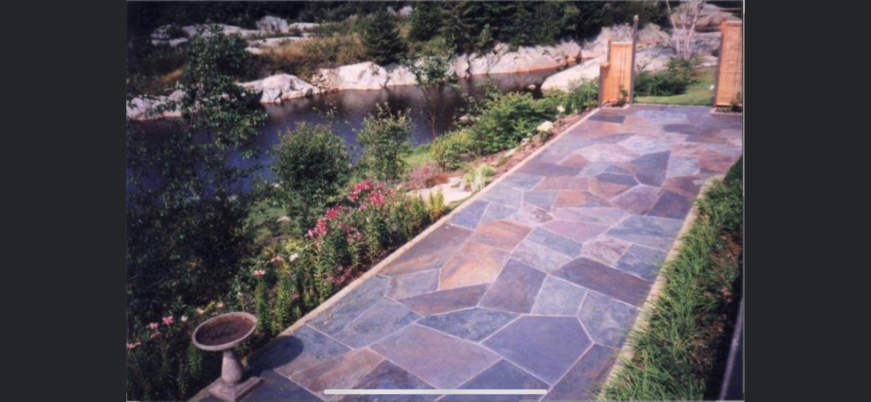 A scotia stone walkway with a river in the background.