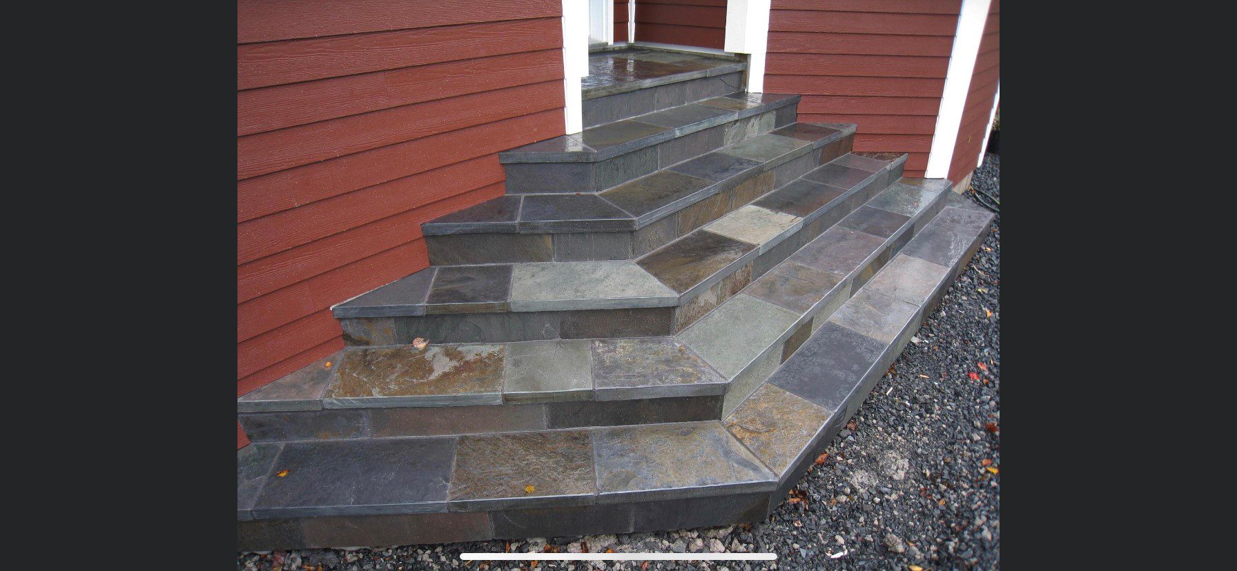 A scotia stone house with steps made of slate.